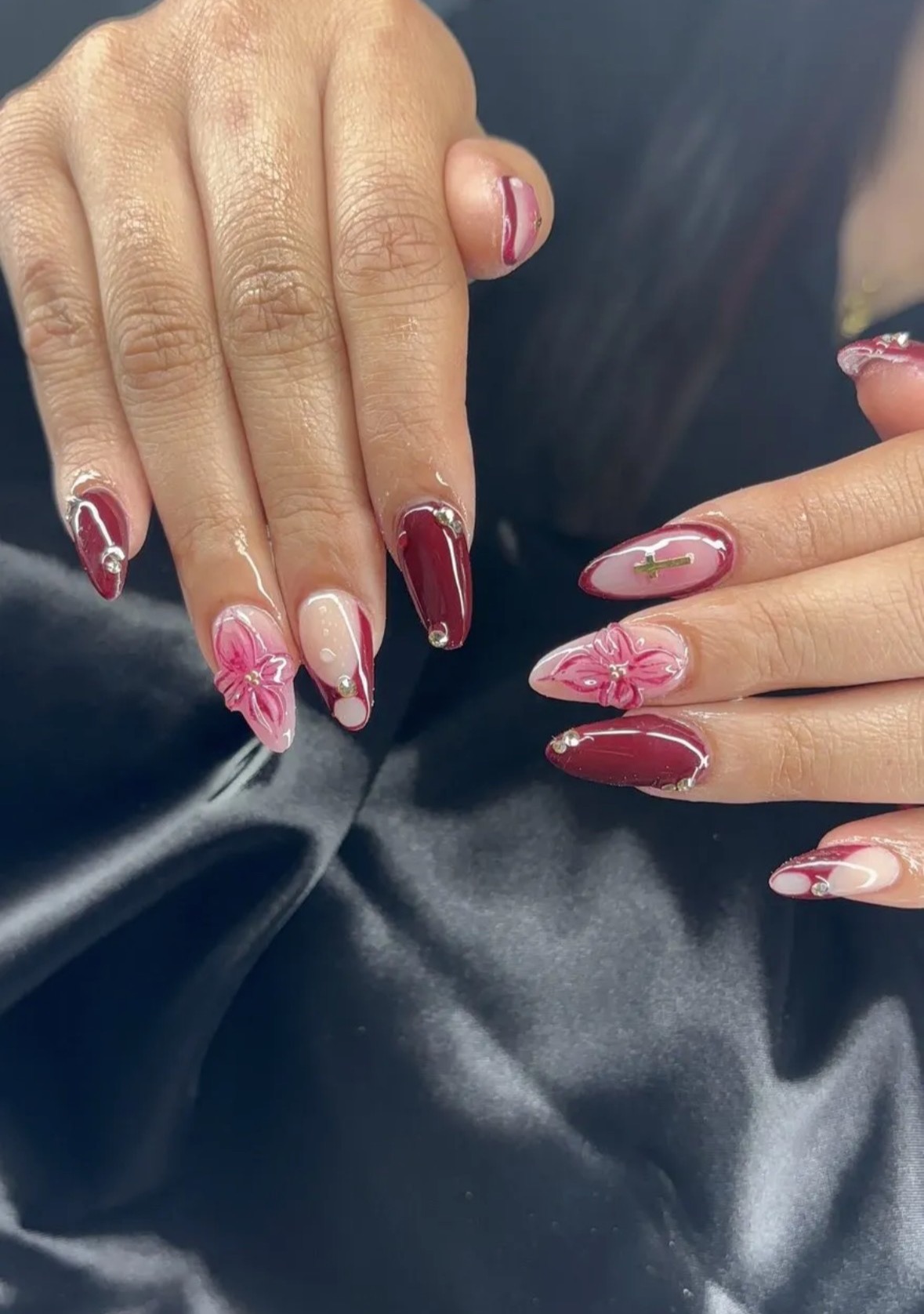 Burgundy floral nails with gold cross charm